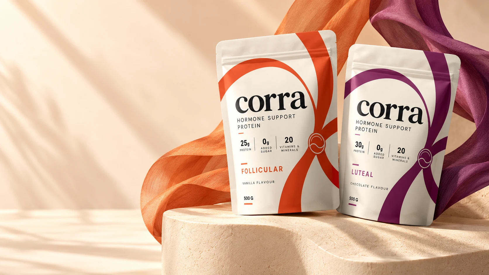 The Follicular and Luteal pouches on a stone plinth with orange and plum silk